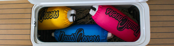 Boat fender covers with bright colors being stowed in boat hull, including NautiCovers branded logo